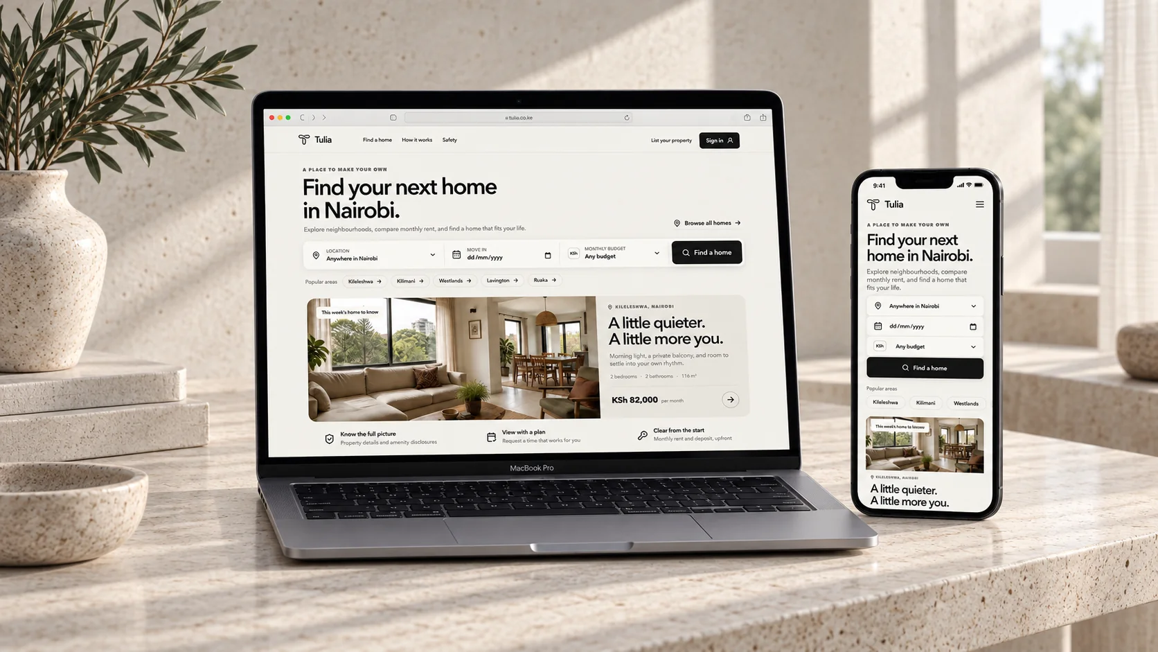 Tulia website on laptop and phone in a softly lit limestone interior